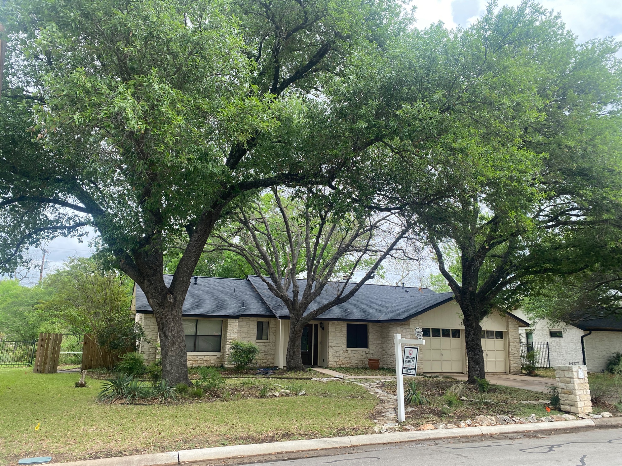 Front view of 1603 West Creek Loop, Round Rock TX — limestone exterior under mature live oaks